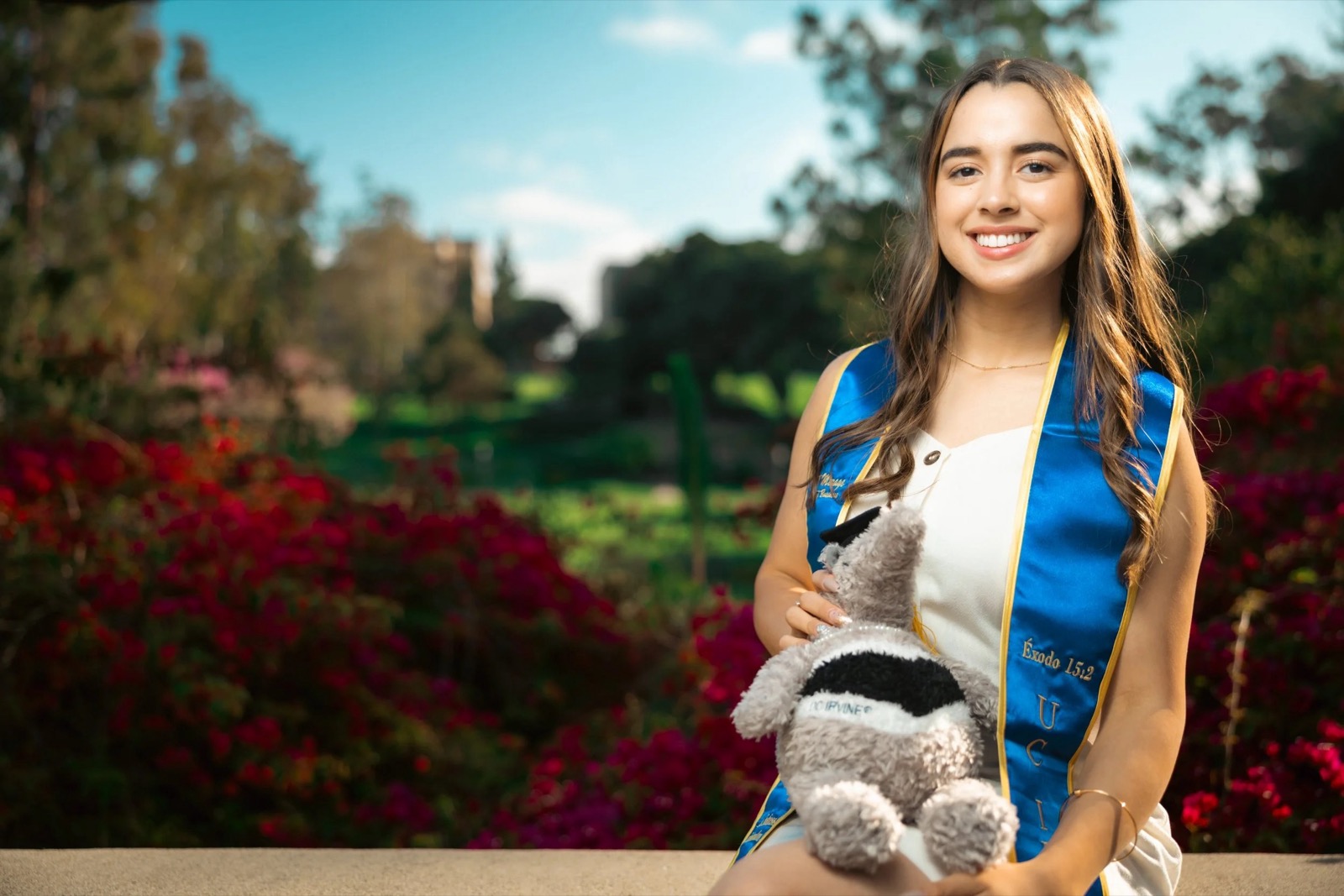 UCI graduate portrait with red flowers