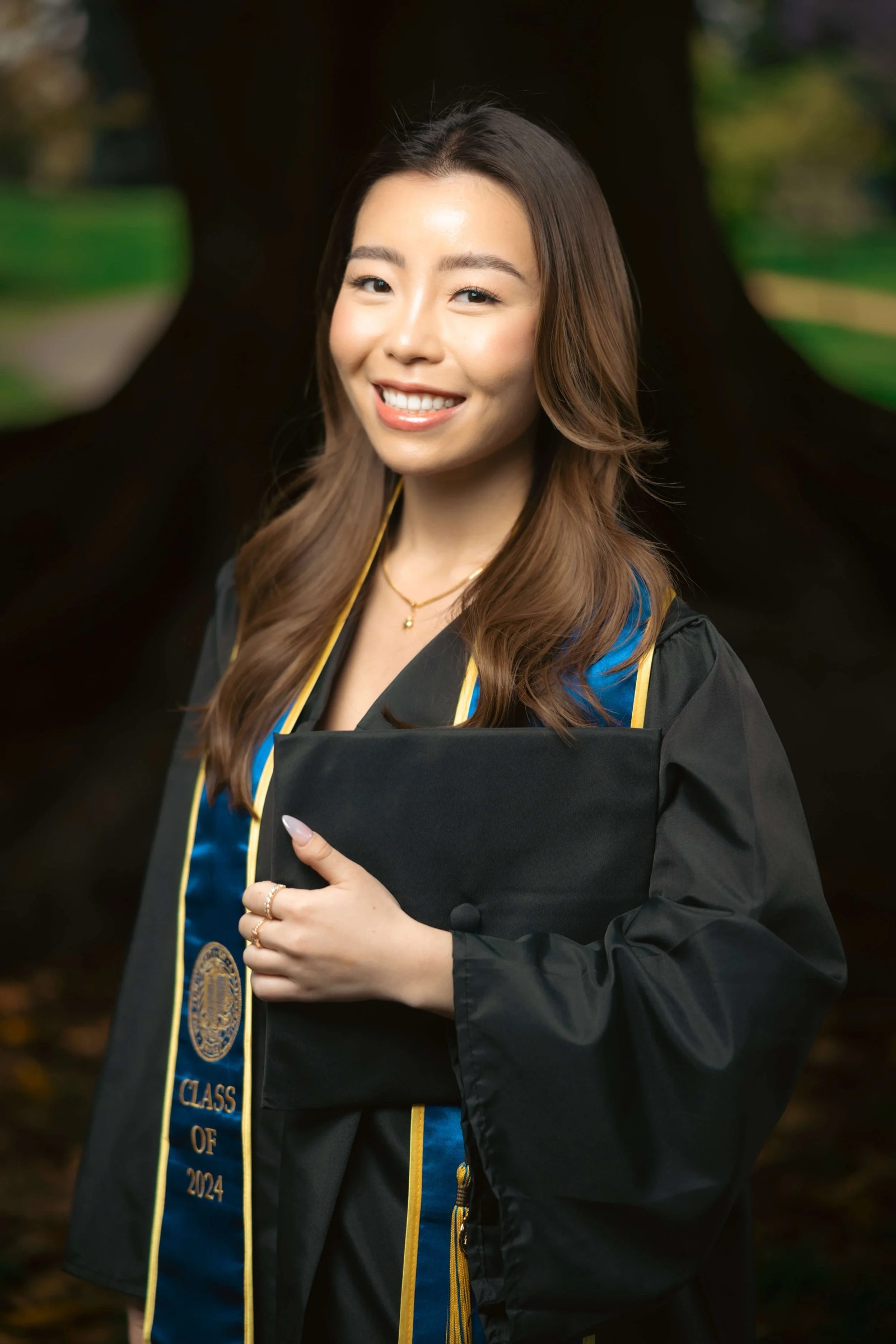 UCI graduate studio-style portrait at big tree in Aldrich Park