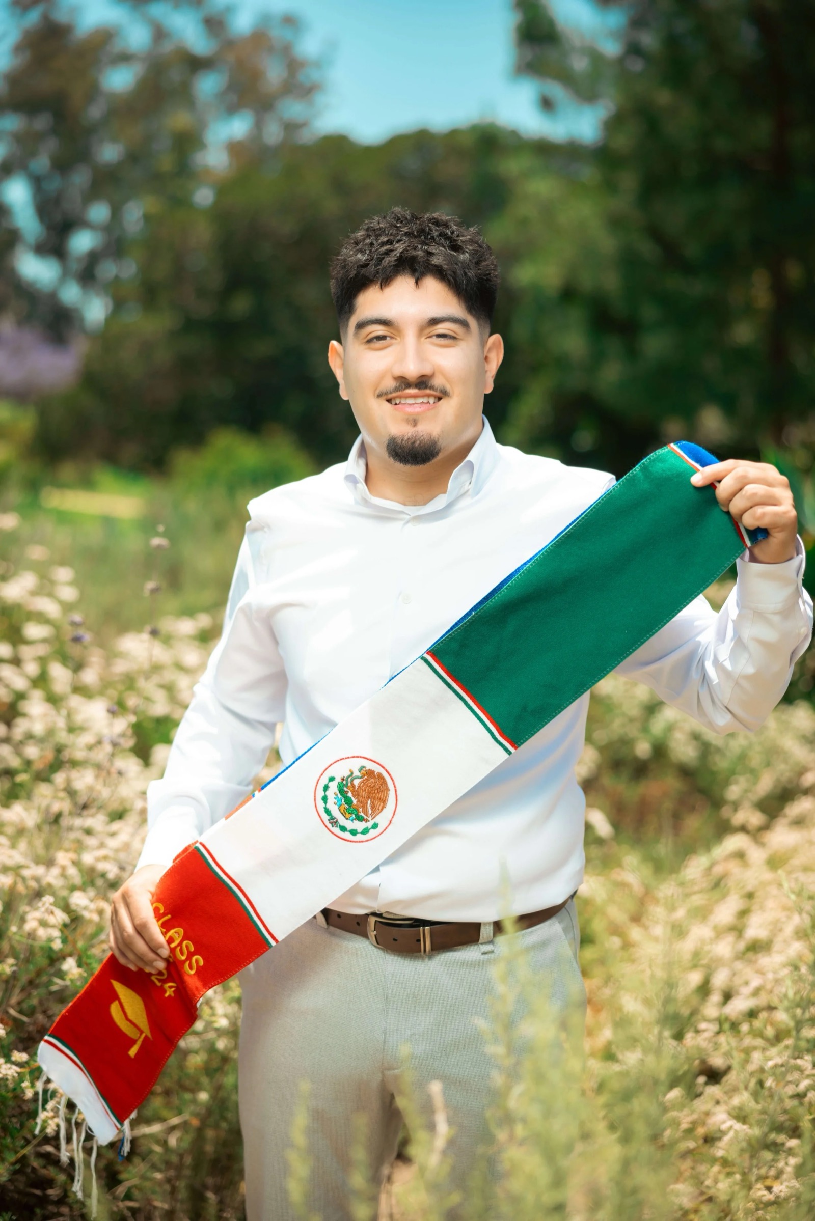 UCI graduate with red flowers direct shot