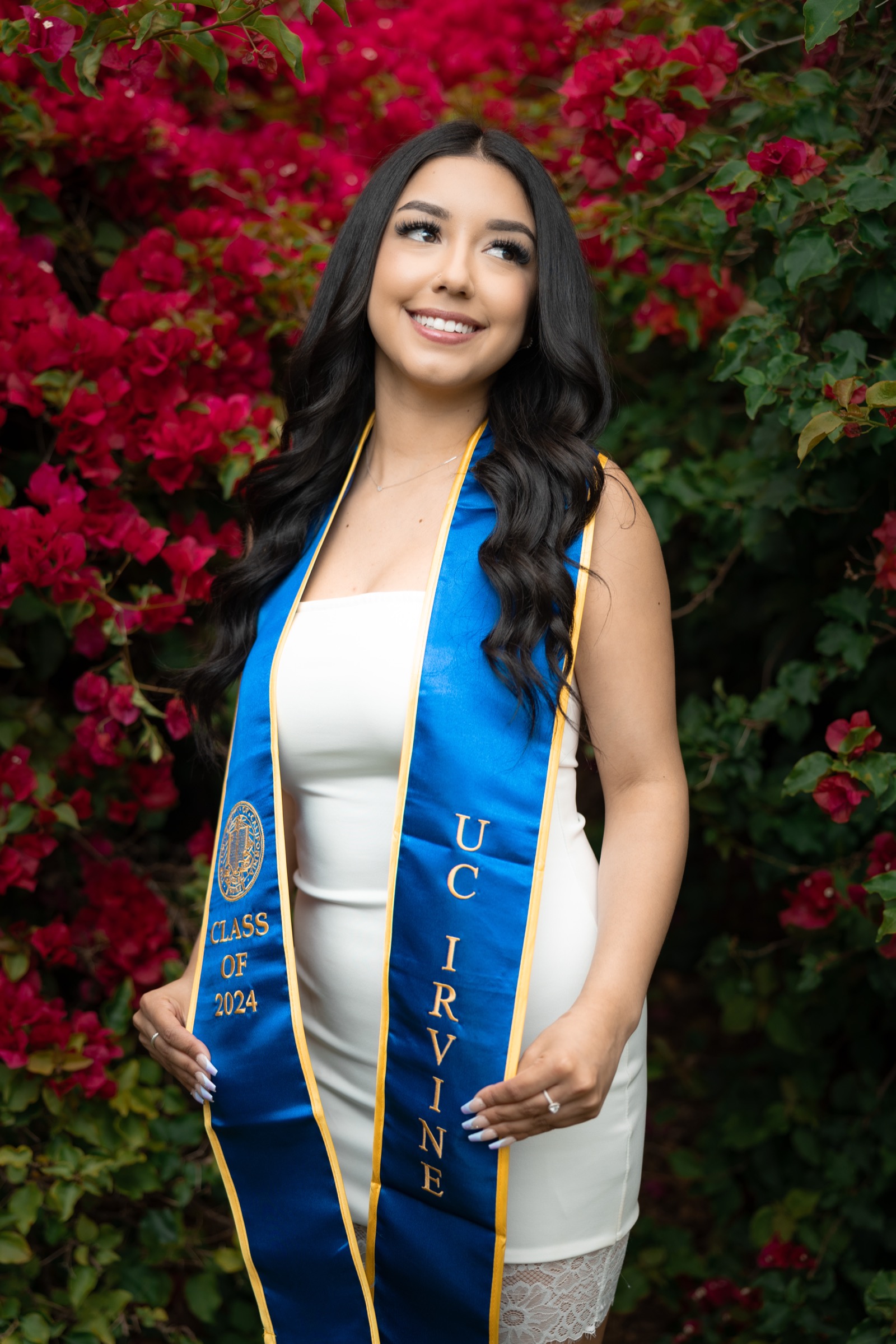 UCI graduate portrait with bougainvillea