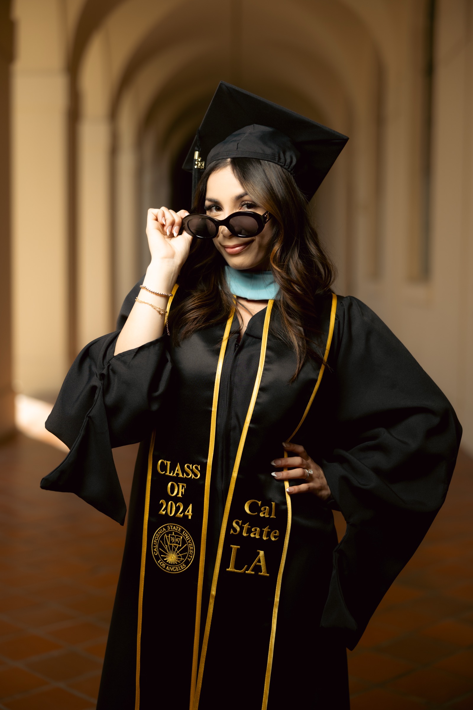 UCI graduate with dog and bougainvillea
