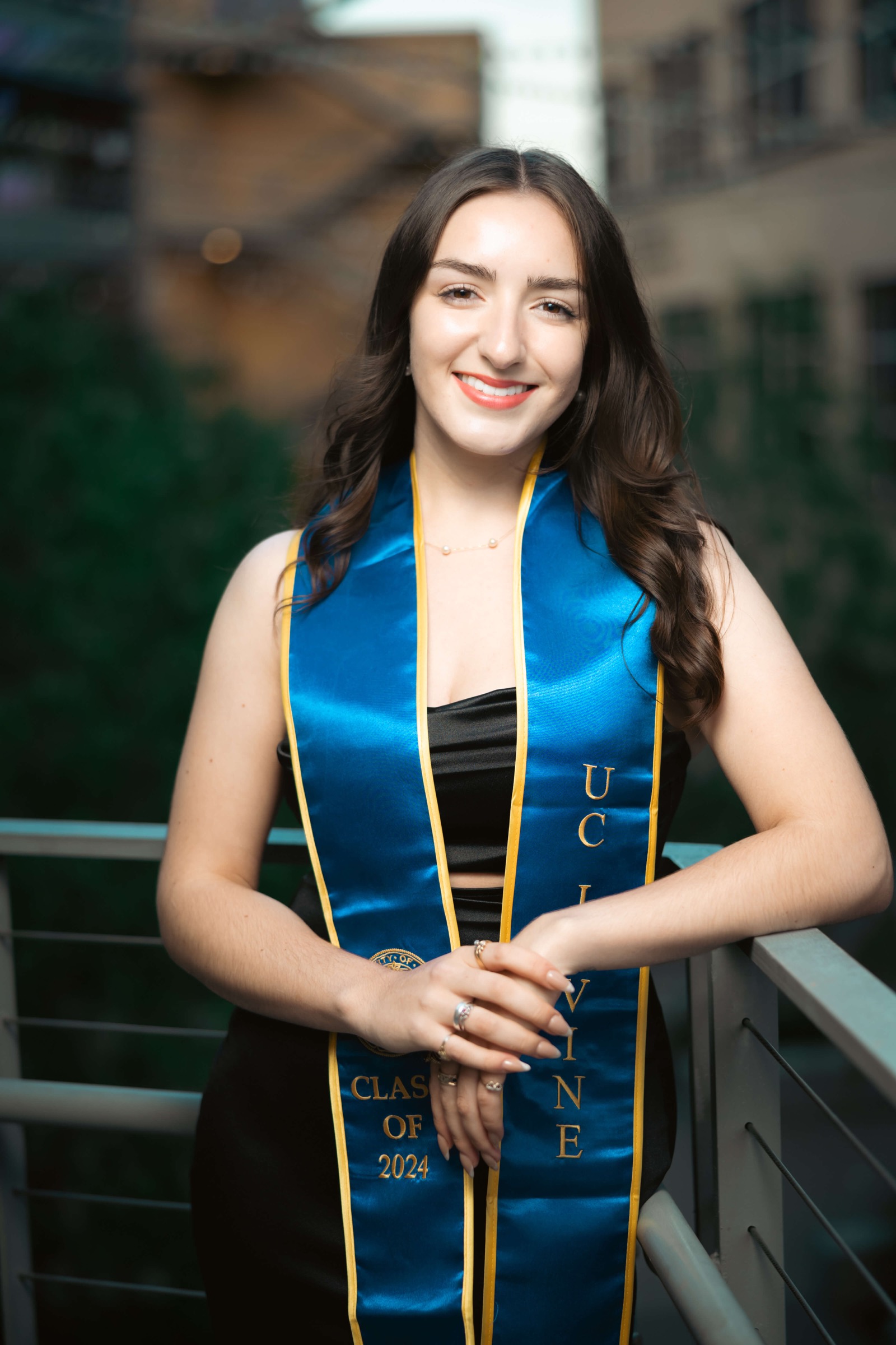 UCI graduate portrait at campus railing