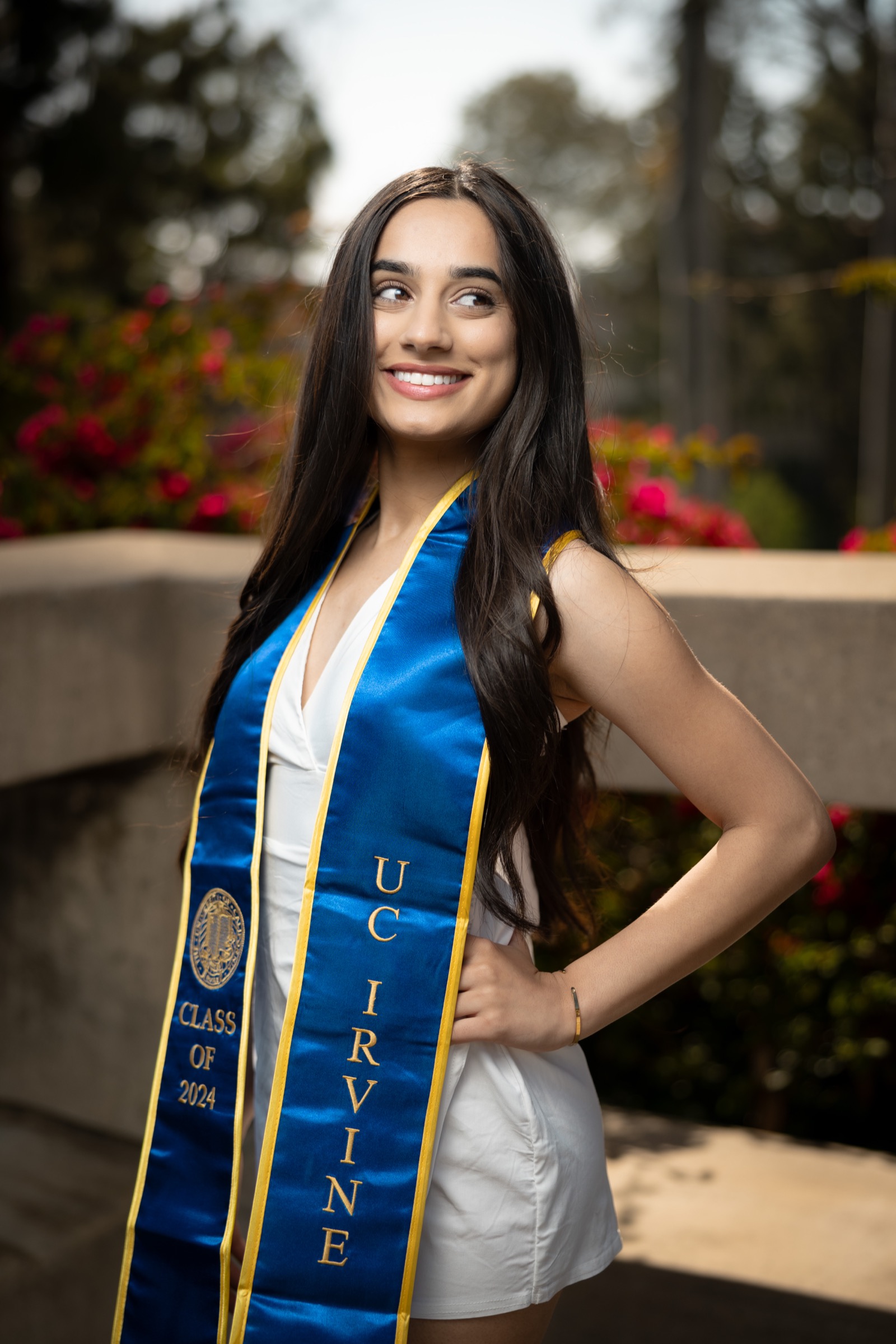 UCI graduate with bougainvillea