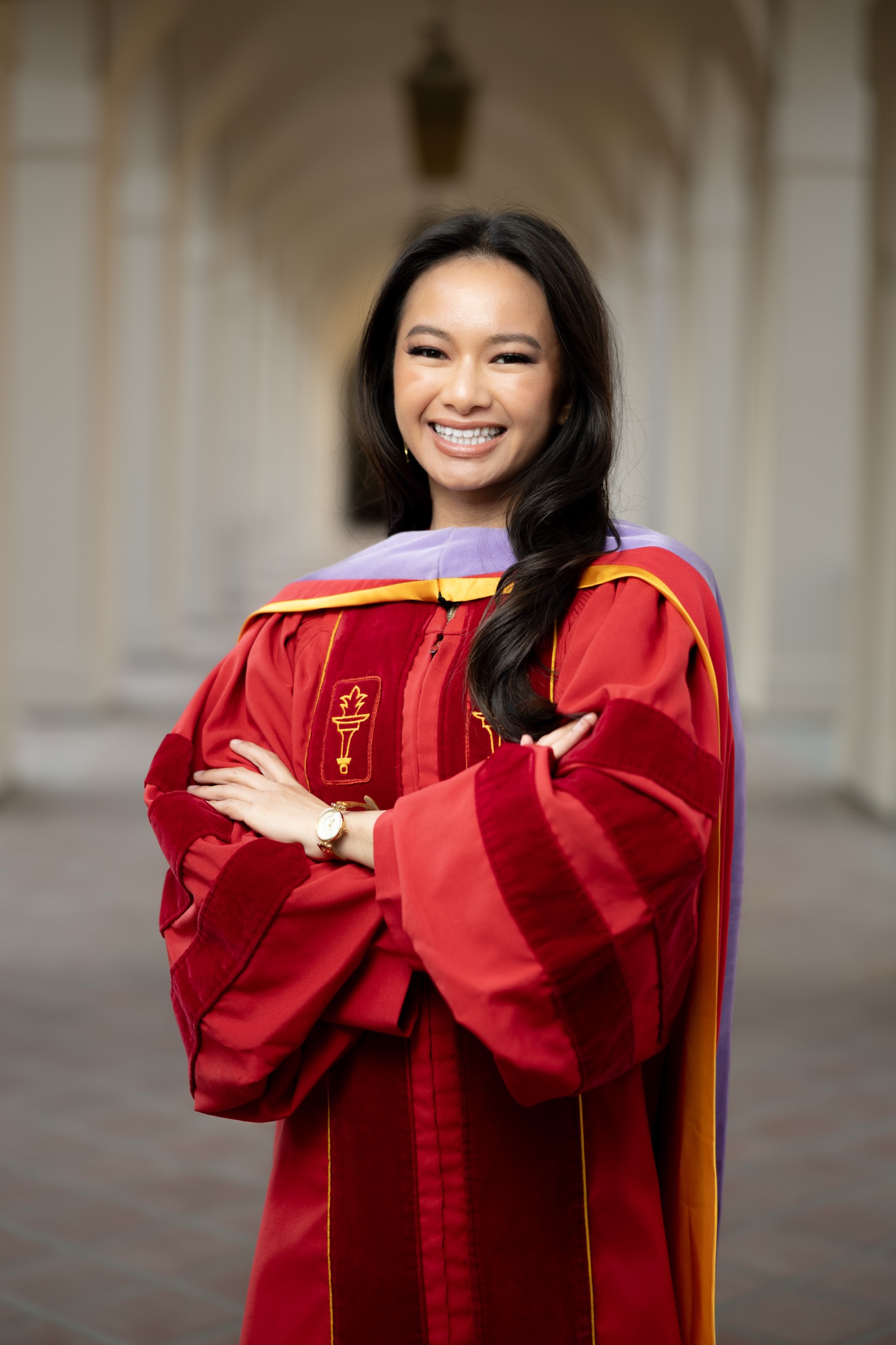 UCI graduate with bougainvillea