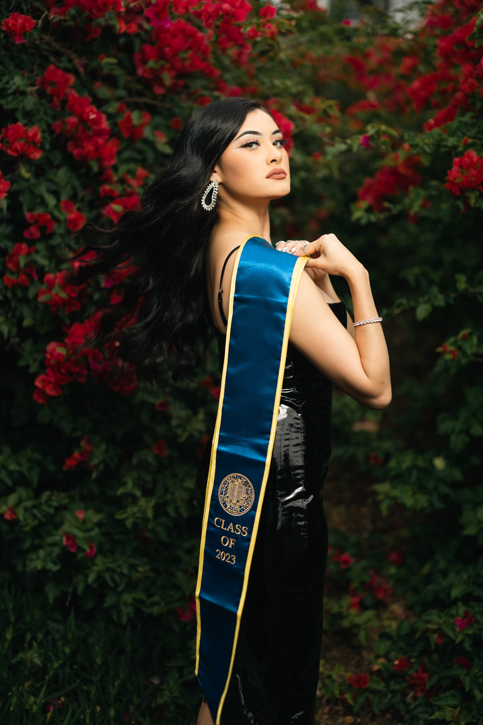 UCI graduate with bougainvillea