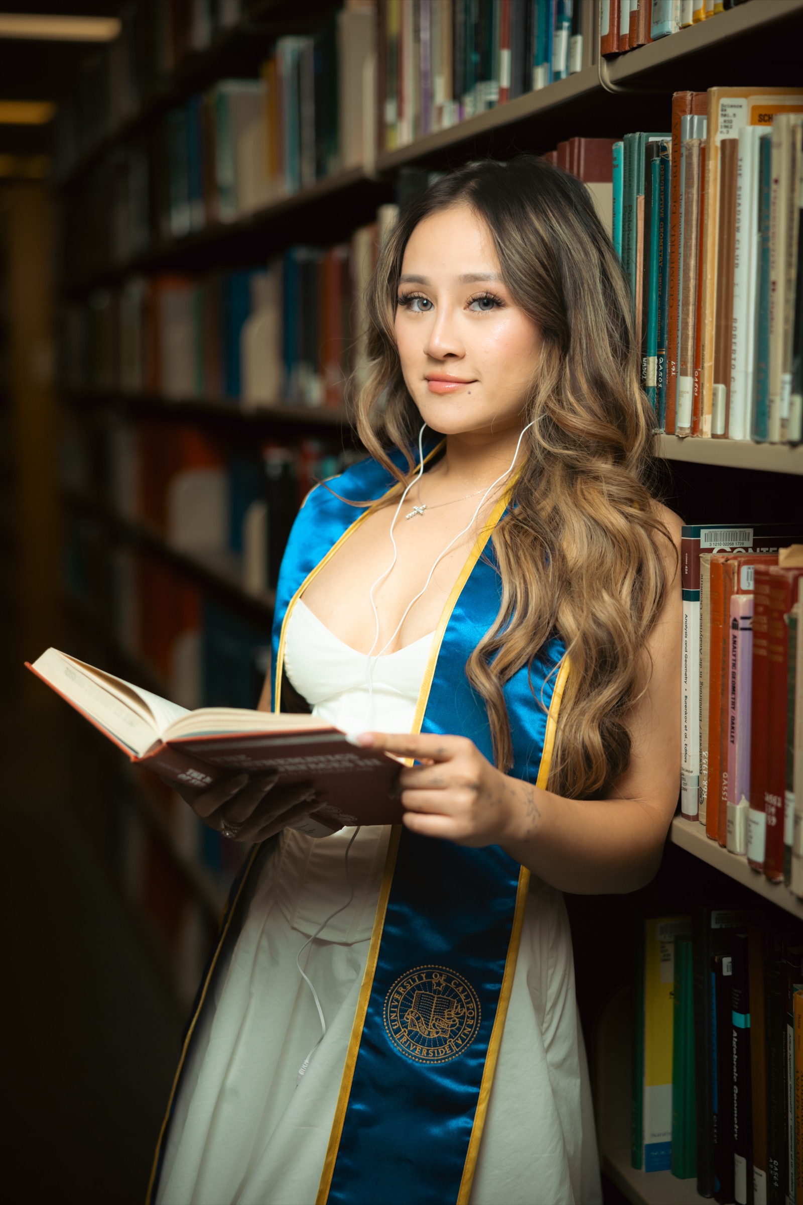 UCI graduate on campus stairs