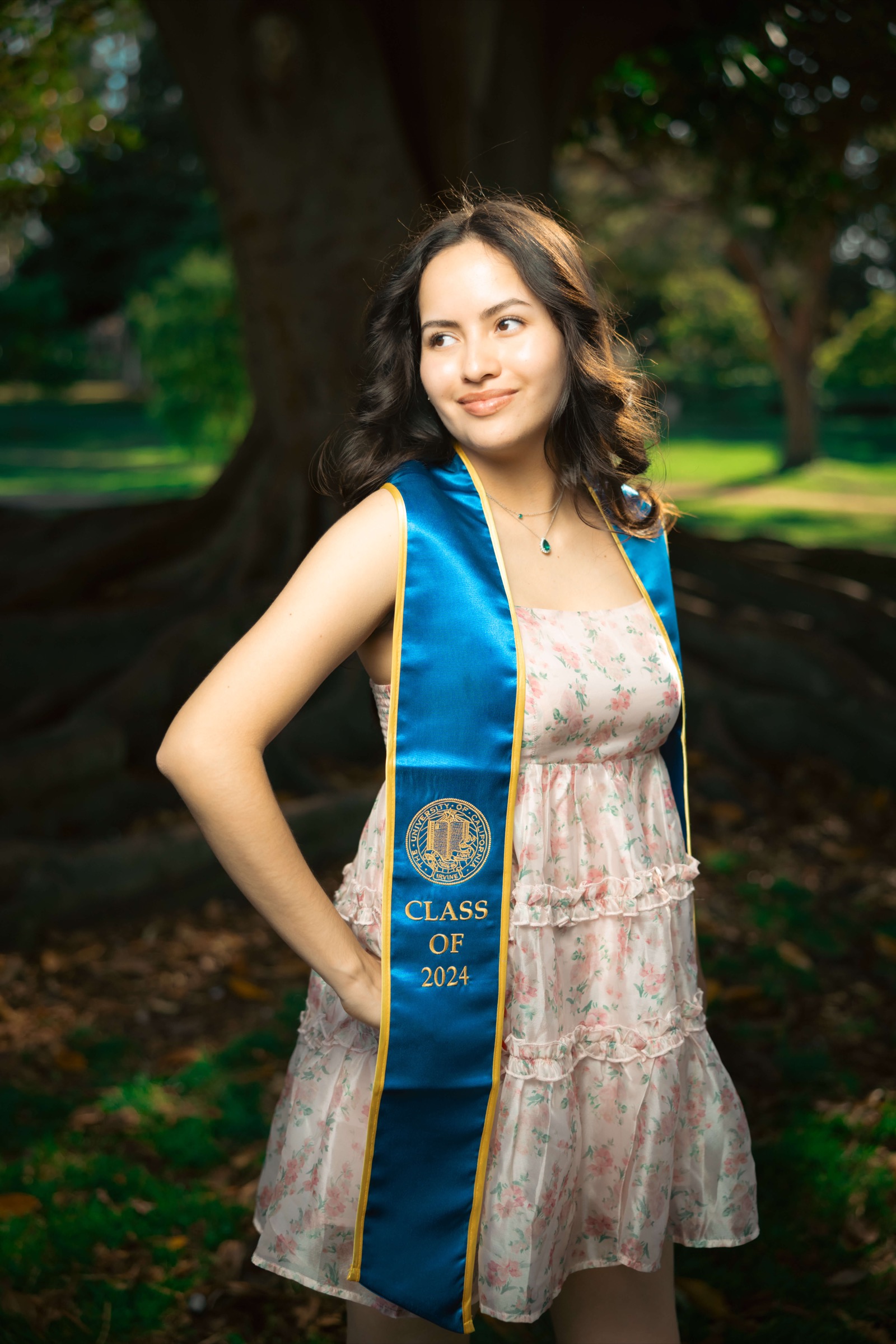 UCI grad with sunglasses and bougainvillea