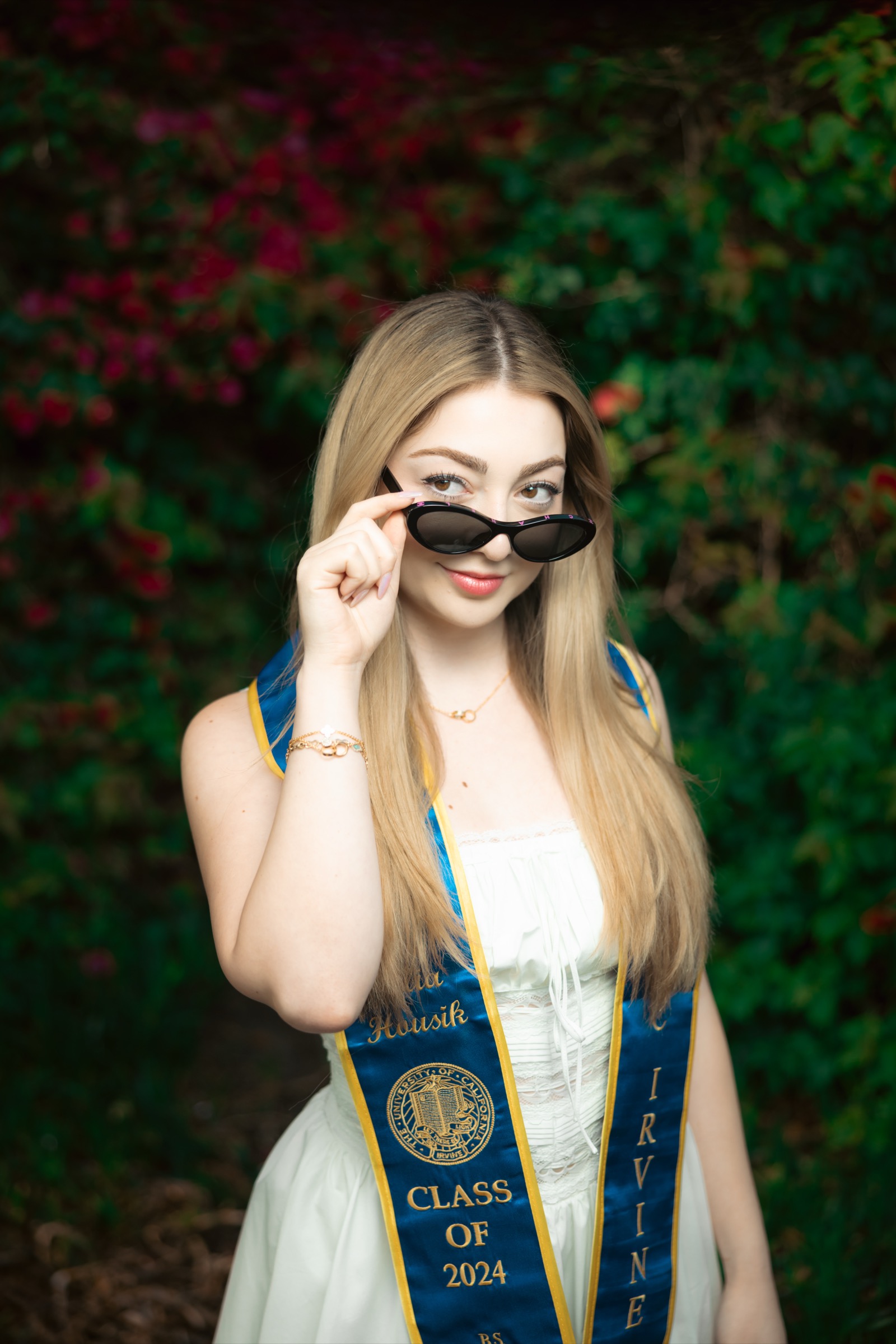 UCI graduate sunglasses portrait with bougainvillea